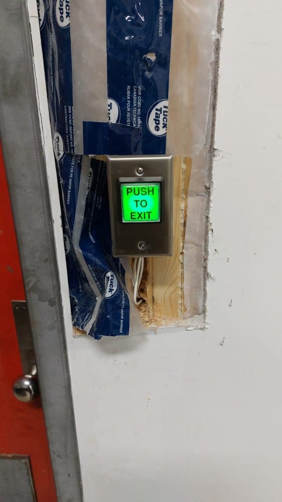 Push-to-exit button installation Illuminated stainless steel Push to Exit button being installed for a security door entry system by Ultimate Security GTA